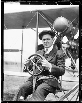 Vintage photo of Lincoln Beachey sitting in a Curtiss stunt plane.